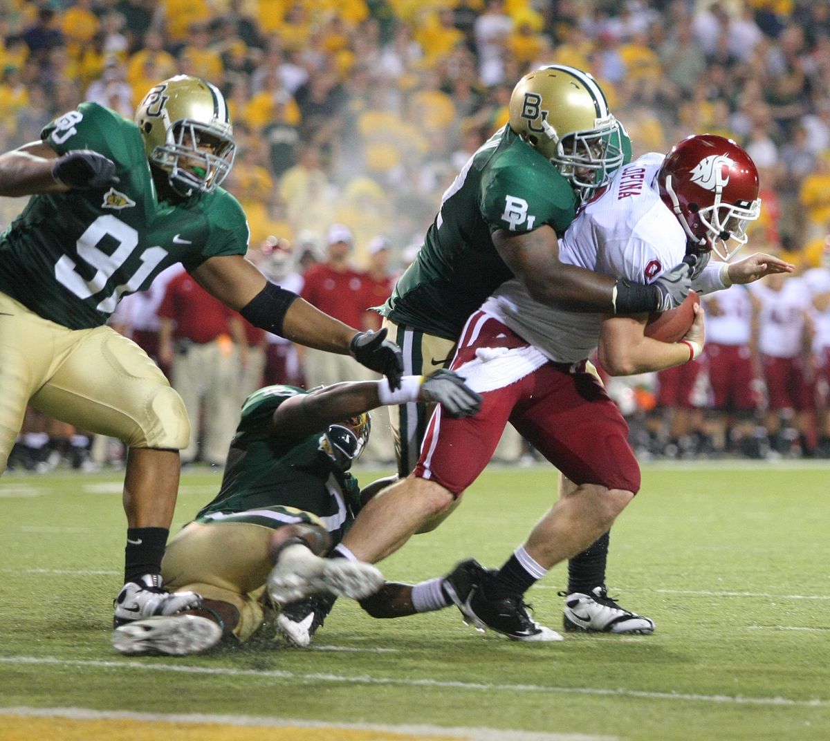 Washington State quarterback Kevin Lopina is ganged up on by Baylor defenders.  (Associated Press / The Spokesman-Review)