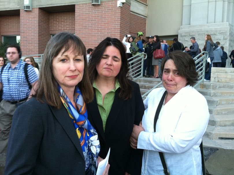 Attorney Deborah Ferguson, left, holds the last-minute stay issued Wednesday morning against same-sex marriages starting in Idaho; at right are two of her clients, Andrea Altmayer and Shelia Robertson. (Betsy Russell)