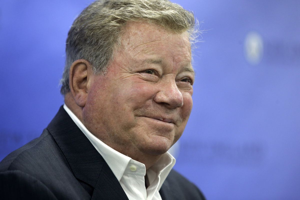 FILE - In this May 6, 2018 file photo, actor William Shatner takes questions from reporters after delivering the commencement address at New England Institute of Technology graduation ceremonies, in Providence, R.I. Star Trek’s Captain Kirk is rocketing into space this month — boldly going where no other sci-fi actors have gone. Jeff Bezos’ space travel company, Blue Origin, announced Monday, Oct. 4, 2021 that Shatner will blast off from West Texas on Oct. 12.  (Steven Senne)