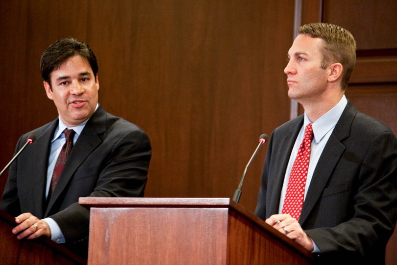 Raul Labrador, left, and Vaughn Ward, right, debate on Tuesday night during the 