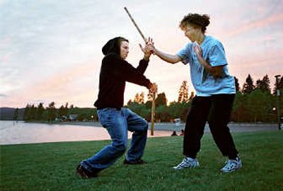 
Eskrima instructor Kristine Strasburger, right, demonstrates self-defense techniques during a recent session at Coeur d'Alene's Independence Point.
 (Photo by Noah Buntain / The Spokesman-Review)