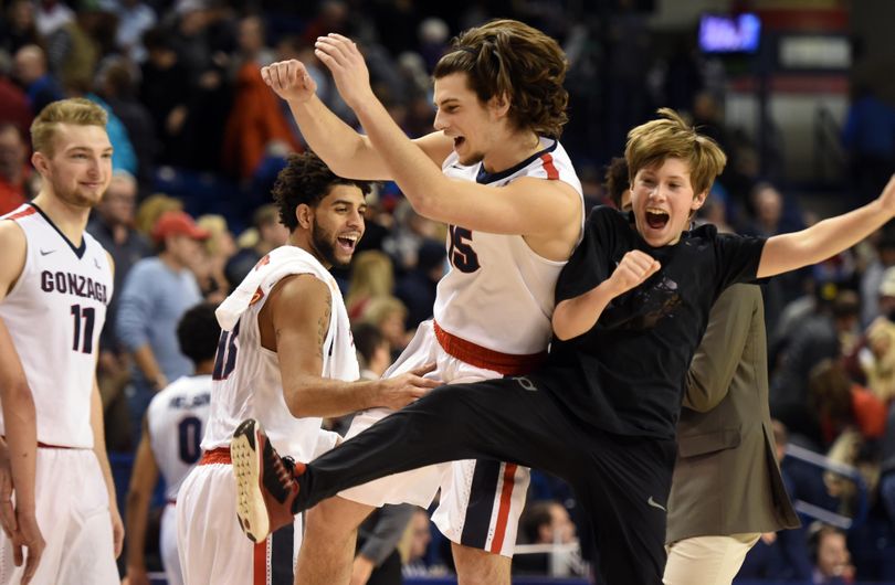 Gonzaga's bencher Rem Bakamas, second from right, celebrates his one minute of substitution and successful three-pointer at the end of the game against Loyola Marymount, Wednesday, Dec. 23, 2015 at McCarthey Athletic Center at Gonzaga University. The Gonzaga Bulldogs won 85-62. (Jesse Tinsley / The Spokesman-Review)