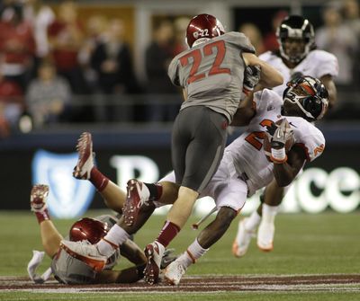 WSU’s Casey Locker (22) delivers a hard hit to OSU’s Markus Wheaton. Locker was flagged for unnecessary roughness on the play. (Associated Press)