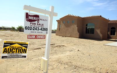 A common sight these days, where auctions, bank-owned homes, foreclosures, and unfinished housing developments dot the housing landscape like this home in Phoenix. (Associated Press / The Spokesman-Review)