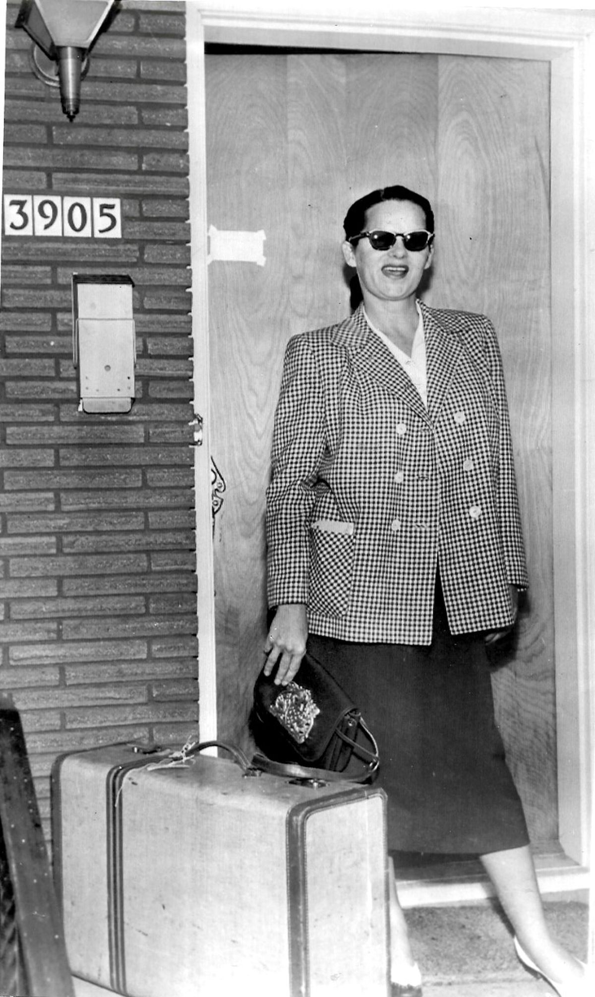 A photo of Virginia Hill in front of her Spokane house at 39th Avenue and South Skyview Drive on the South Hill appeared in October 1955 in the Houston Post. The Post’s caption read: “Spokane, Wash. LOCKED OUT. A miffed Virginia Hill arriving with baggage but barred from her expensive home by a treasury agent.”  (Courtesy of Darin Krogh/For The Spokesman-Review)
