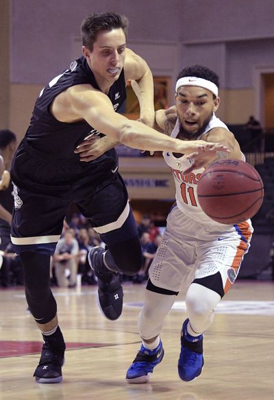 Gonzaga forward Zach Collins, left, and Florida guard Chris Chiozza  battle for the ball during the first half Friday. (Phelan M. Ebenhack / Associated Press)