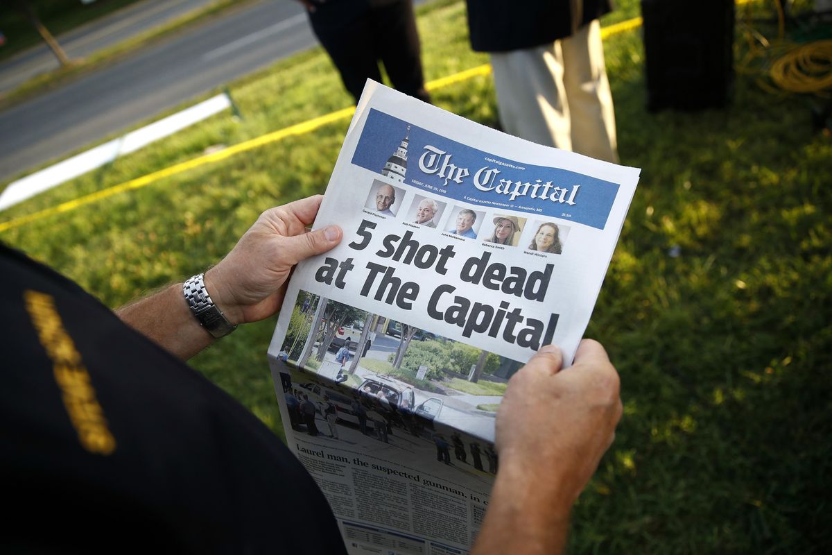 Steve Schuh, county executive of Anne Arundel County, holds a copy of The Capital Gazette near the scene of a shooting at the newspaper’s office, Friday, June 29, 2018, in Annapolis, Md. A man armed with smoke grenades and a shotgun attacked journalists in the building Thursday, killing several people before police quickly stormed the building and arrested him, police and witnesses said. (Patrick Semansky / Associated Press)