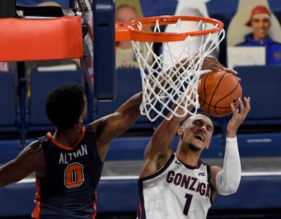 Gonzaga’s Jalen Suggs, who scored 18 points, draws a foul on Pepperdine’s Sedrick Altman during the first half of the Bulldogs’ 95-70 home win on Jan. 14.  (By Colin Mulvany / The Spokesman-Review)