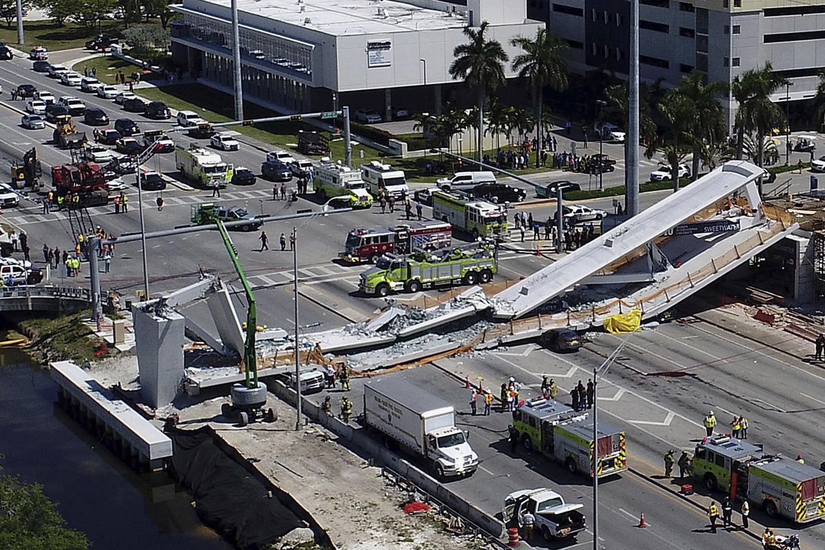 Emergency personnel respond after a brand-new pedestrian bridge collapsed onto a highway at Florida International University in Miami on Thursday, March 15, 2018. The pedestrian bridge collapsed onto the highway crushing multiple vehicles and killing several people. (Pedro Portal / Associated Press)