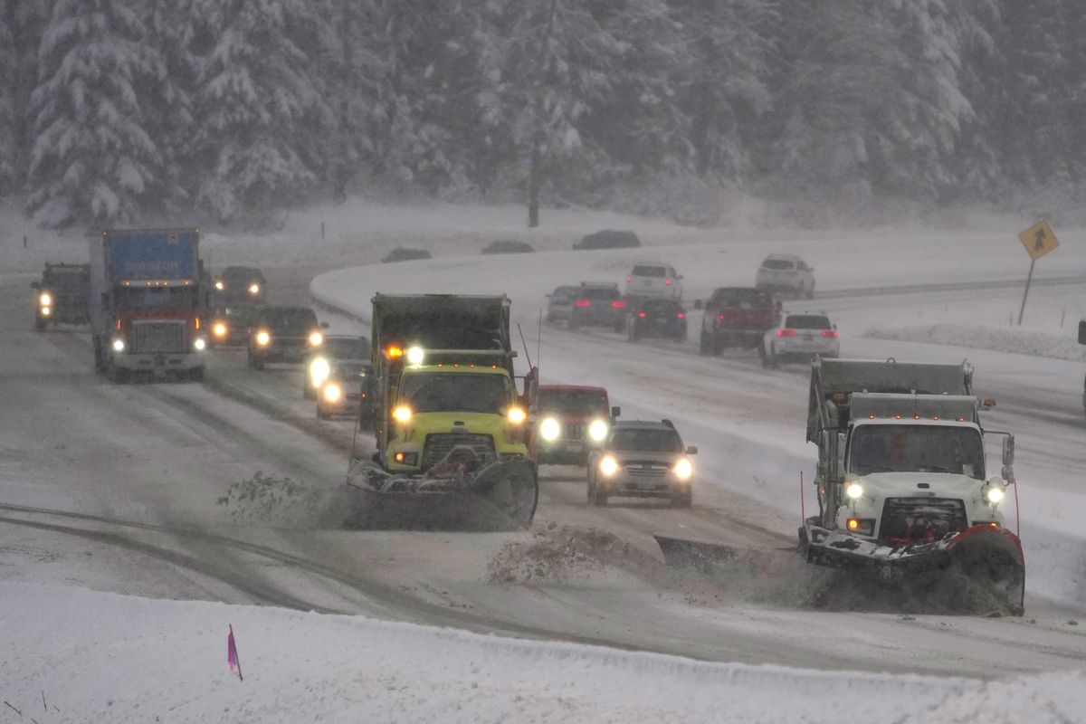 Washington Dept. of Transportation snow plows work on a stretch of eastbound Interstate Highway 90, Thursday, Dec. 9, 2021, as snow falls near Snoqualmie Pass in Washington state. More U.S. drivers could find themselves stuck on snowy highways or have their travel delayed this winter due to a shortage of snowplow drivers as some states are having trouble finding enough people willing to take the jobs.  (Ted S. Warren)