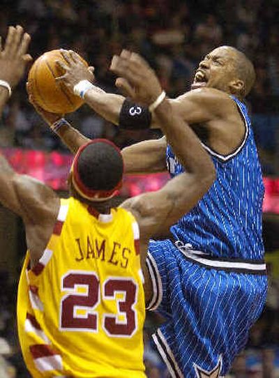 
Orlando Magic's Steve Francis, right, fails to get a shot off as Cleveland Cavaliers' LeBron James defends during the third quarter of Cleveland's win Tuesday.
 (Associated Press / The Spokesman-Review)