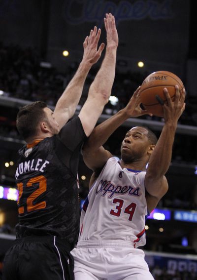 Clippers guard Willie Green drives against Suns center Miles Plumlee during the first half. Los Angeles won 112-105. (Associated Press)