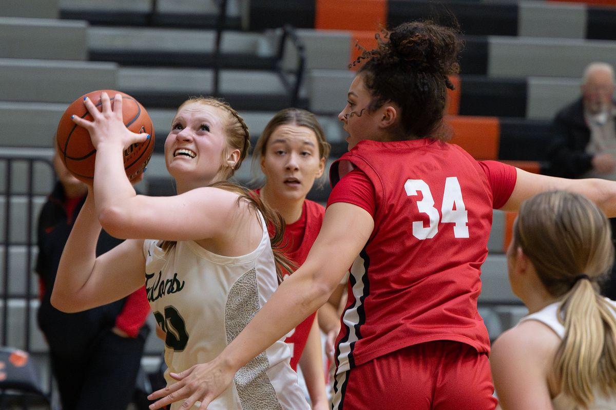 Ridgeline post Madi Crowley (30) eyes the basket as Snohomish forward Tyler Gildersleeve-Stiles (34) defends during the 13th annual Dan Fitzgerald Memorial Basketball Showcase, Friday, Dec. 6, 2024, at Lewis and Clark High School.  (COLIN MULVANY)