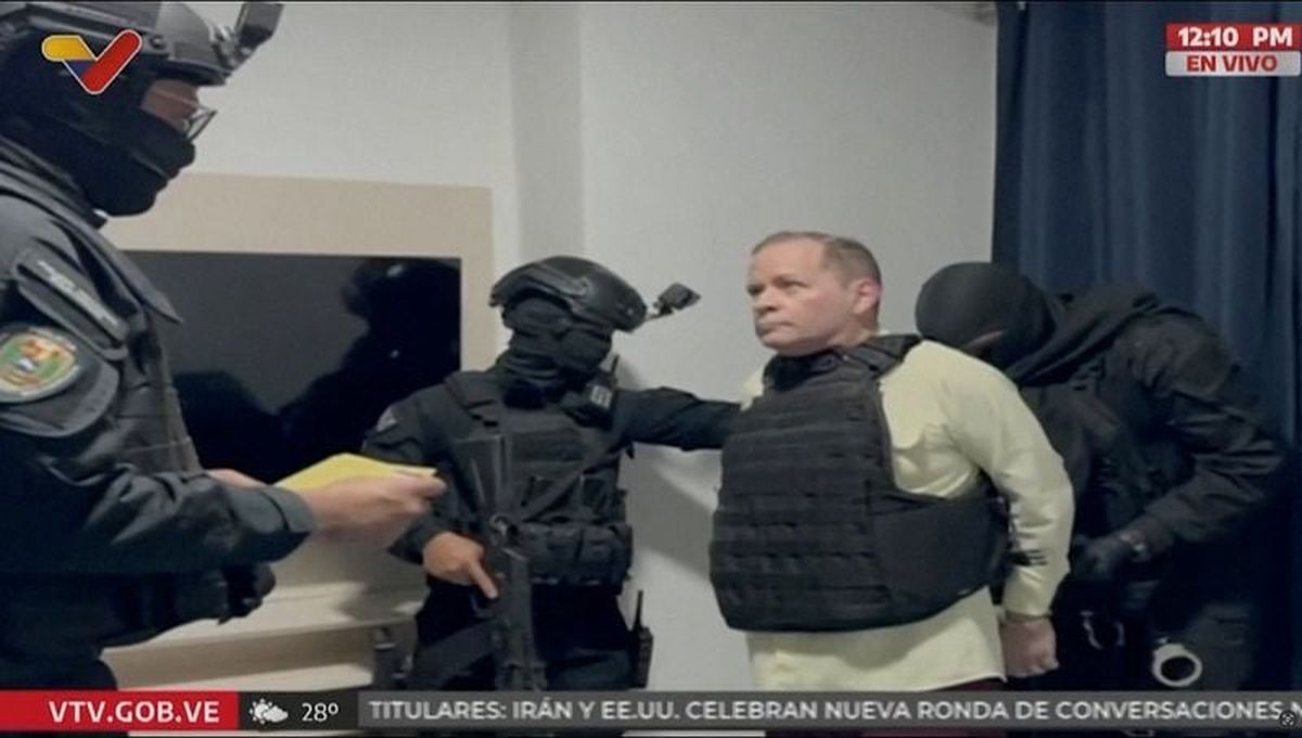 Venezuela opposition leader Juan Pablo Guanipa, wearing a bulletproof vest, looks on as he is handcuffed on May 23 after being detained by Venezuelan law enforcement officers at an unknown location.  (Venezuelan Government TV)
