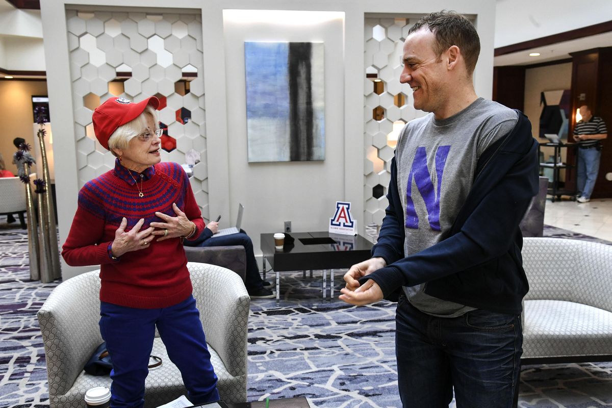 Kyle Henneberry, right, of Woodinville, Washington, is a 1993 Ferris High School grad and a former walk-on basketball player at Northwestern University. He shows his Northwestern Wildcats tee shirt to Gonzaga fan Phyllis Carney, of Seattle, during a chance meeting at the Salt Lake Marriott Downtown at City Creek, March 17, 2017. Dan Pelle/THE SPOKESMAN-REVIEW (Dan Pelle / The Spokesman-Review)