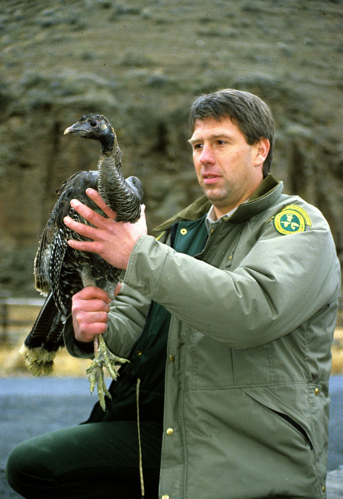 Andrews, holding a wild turkey above, dealt with public assets ranging from skunks to grizzlies.