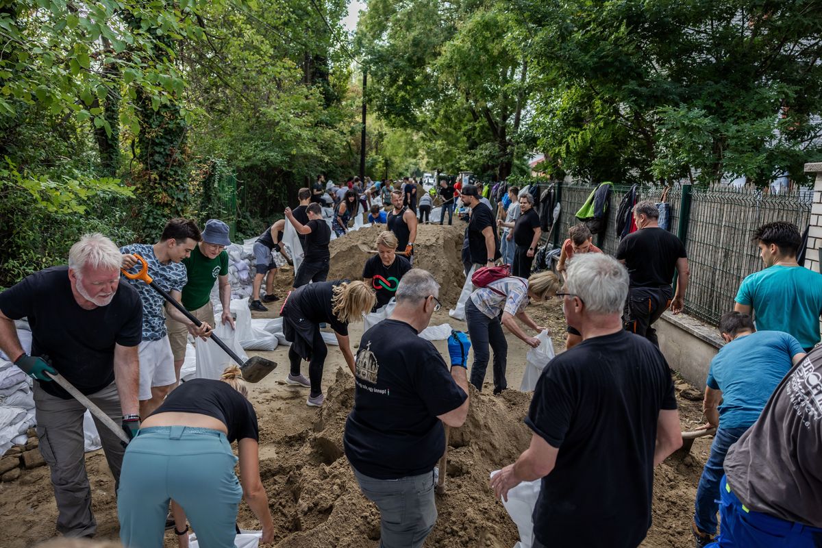 Above: People build a dam from sandbags as a protection against the flooded Danube River on Wednesday in Budapest, Hungary. Hungary expects flood waters to peak by Friday this week as storm Boris has already wreaked havoc across Europe. Left: Properties are damaged as floodwaters rise following heavy rain on Sunday in Jesenik, Czech Republic. There have been extreme weather and flood warnings as heavy rainfall sweeps the Czech Republic, Poland, Germany, Austria and Slovakia.  (Janos Kummer)