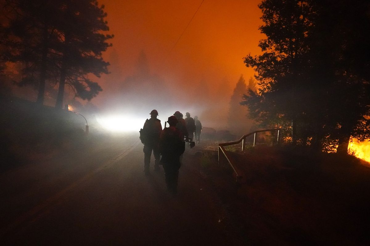 Members of the Laguna Hotshots, out of the Cleveland National Forest, walk on a road while fighting the Creek Fire, Sunday, Sept. 6, 2020, in Big Creek, Calif.  (Marcio Jose Sanchez)