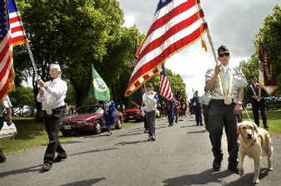 
Jack O'Dowd, right, presents the colors with his guide dog, Jill, in the Fairfield Flag Day parade Saturday.  O'Dowd fought in the Korean War, where he was wounded several times. 
 (Holly Pickett / The Spokesman-Review)