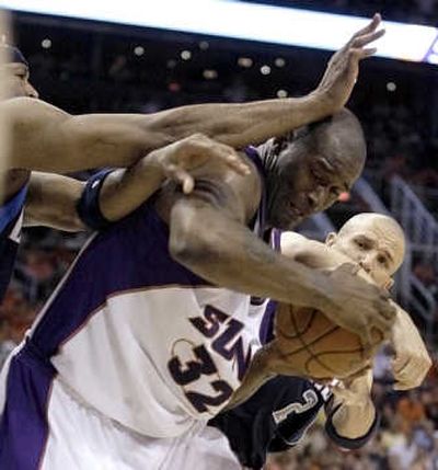 
Shaquille O'Neal, center, and the Suns couldn't hold onto a big lead against the Mavericks on Sunday. Associated Press
 (Associated Press / The Spokesman-Review)