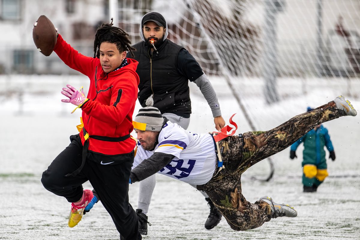 Isaiah Griffin with team Fear the Scherer runs out of bounds as Chuck Bernhard with team Altar CDA dives for his flags during the third annual Scherer Charity Bowl flag football game held Saturday in Post Falls.  (COLIN MULVANY/THE SPOKESMAN-REVI)