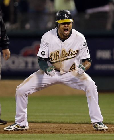 Coco Crisp celebrates after his single in the ninth inning capped a three-run A’s rally. (Associated Press)