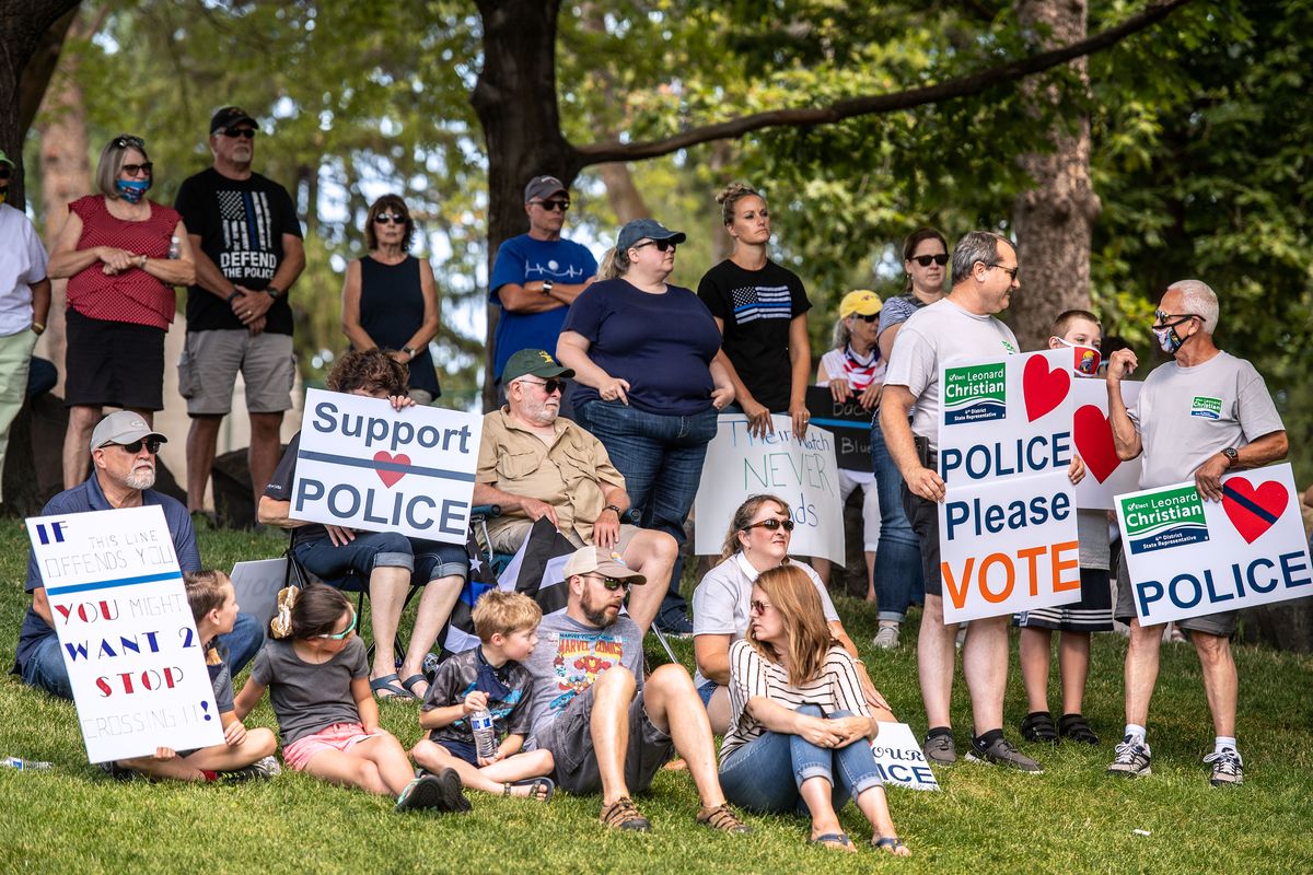 Supporters of the police gather in the shade during a Law Enforcement Support Rally sponsored by Family of Faith Community Church, Sat., July 18, 2020, in Riverfront Park.  (Colin Mulvany/THE SPOKESMAN-REVIEW)