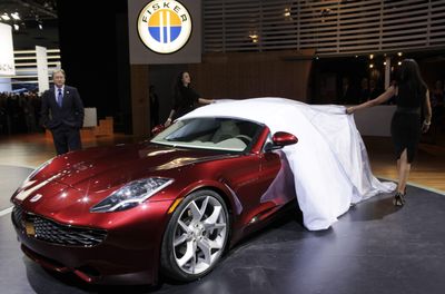 With CEO Henrik Fisker, left, standing by, Fisker Automotive unveils its Karma S plug-in hybrid hardtop convertible concept car at the North American International Auto Show on Monday in Detroit.  (Associated Press / The Spokesman-Review)