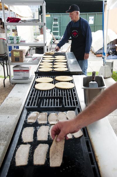 John Searle, top, and Jeff Stenfors, grill gyros pita bread and meat, Sept. 24, 2015, at the Holy Trinity Greek Orthodox Church’s annual Greek Dinner Festival last year. The 81st edition of the event kicks off on Thursday. (Dan Pelle / The Spokesman-Review)