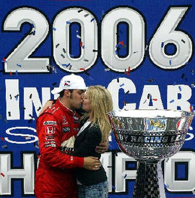 
IRL driver Sam Hornish Jr., kisses his wife Crystal as he celebrates after winning the Indy Racing League at Chicagoland Speedway. 
 (Associated Press / The Spokesman-Review)