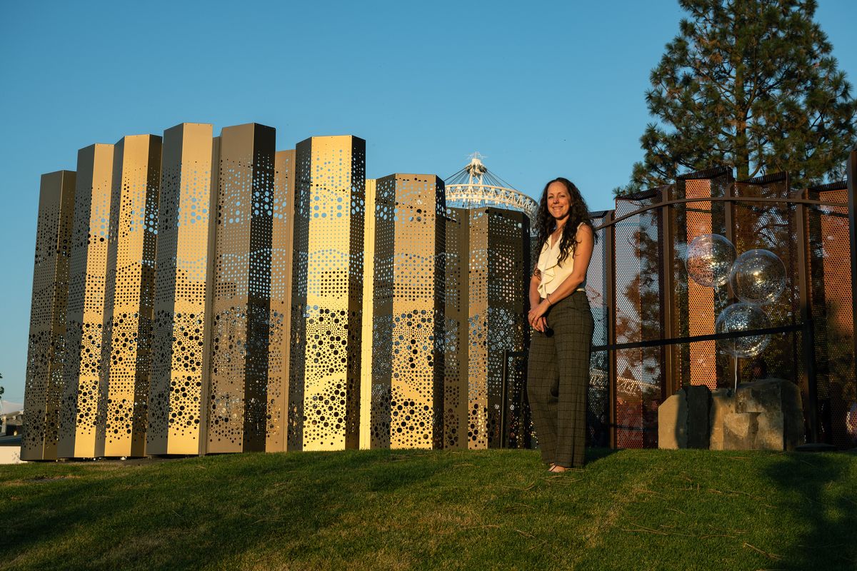 Sarah Thompson Moore stands front of The Seeking Place just before it was unveiled to the public in a ceremony and ribbon cutting Tuesday evening in Riverfront Park. The Seeking Place is made of perforated anodized aluminum panels, with inspiration drawn from the region’s basalt outcroppings.  (COLIN MULVANY/THE SPOKESMAN-REVI)
