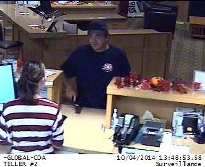 In this FBI photograph published Oct. 5, 2014, a man believed by authorities to be Randy T. Jordan is seen attempting a robbery of a Coeur d'Alene credit union. (FBI)