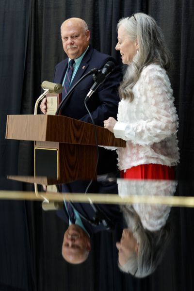 Washington State University’s retired police chief, Gary Jenkins, is recognized by WSU Chief Financial Officer Leslie Brunelli during a ceremony on Friday at the Holland and Terrell Libraries Atrium in Pullman.  (Geoff Crimmins/For The Spokesman-Review)