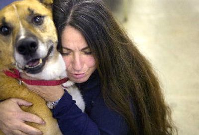 
Patricia Simonet hugs Adam this week at Spokane Regional Animal Protection Services (SCRAPS). Simonet has recorded dog laughter and found that the sound calms the animals at the shelter. 
 (Holly Pickett / The Spokesman-Review)