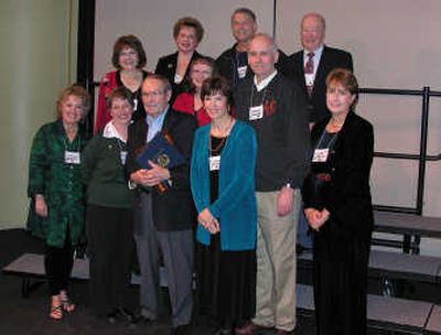 
Gerald Hartley holds the plaque he received Saturday, surrounded by Reunion Committee members, from left, top row, Kathleen Blair, Richard Ellis, Bill Anderson; 2nd Row: Joan Polzin, Carol Miyamoto, Berne Indahl, Lois Berg, and, front row, Connie Christman, Sandy Riebe, and Laurie Dolan. Courtesy of John D. Brown
 (Courtesy of John D. Brown / The Spokesman-Review)