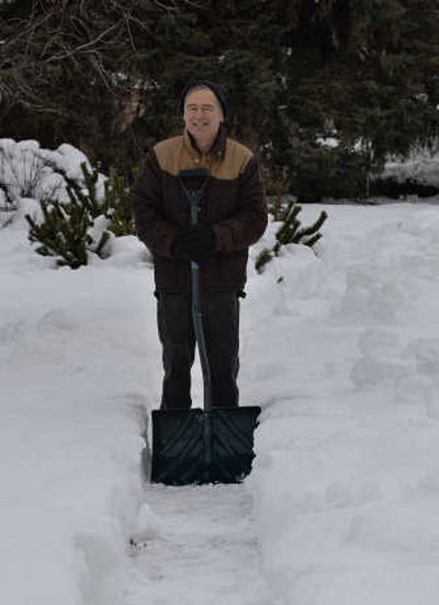 
Roger Repp shovels a walkway through the snow in Margaret Johnson's yard every winter and trades in his shovel for a lawnmower in the summer. 
 (Liz Kishimoto / The Spokesman-Review)