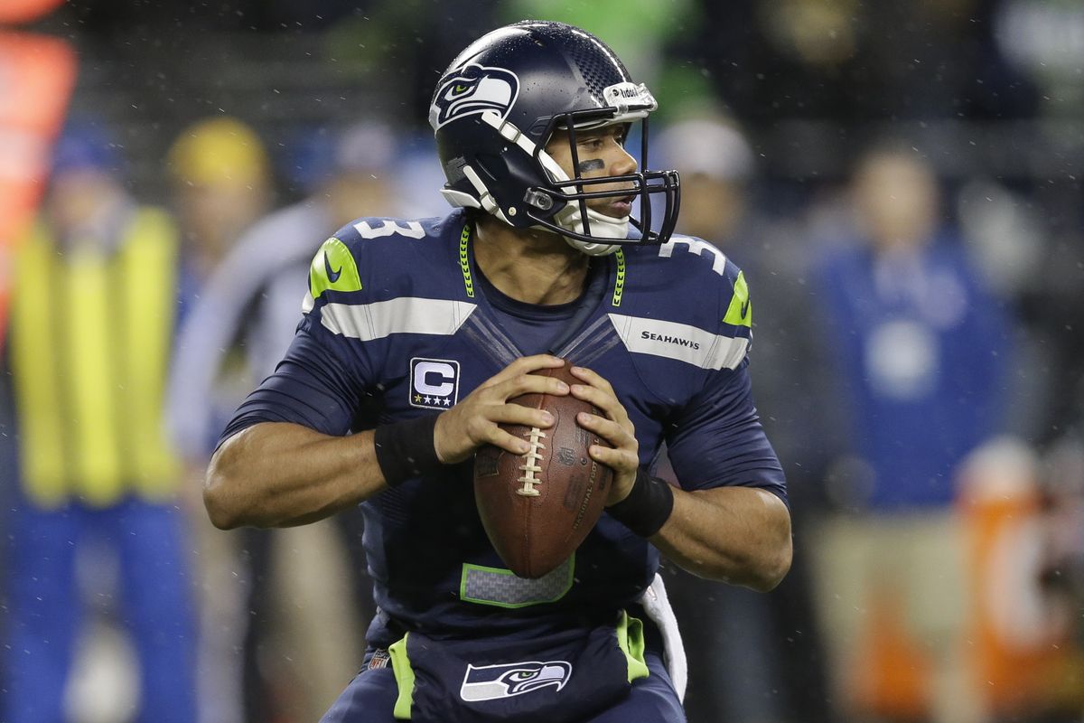 Russell Wilson completed 22 of 30 passes for 310 yards and three TDs. (Associated Press)