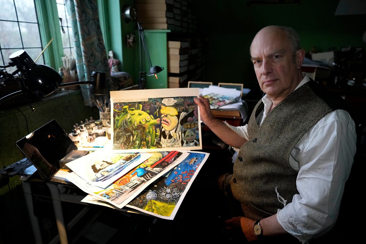 The Guardian political cartoonist Martin Rowson shows some of his work Jan. 24 in his London studio.  (Frank Augstein)