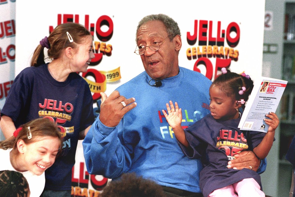 Comedian Bill Cosby talks with schoolchildren, from bottom left, Laura Wing, Kathryn Wing and Aliyah Thomas in April 1999 at the Harold Washington Library in Chicago. Cosby was celebrating 25 years as pitchman for Jell-O. (Associated Press)