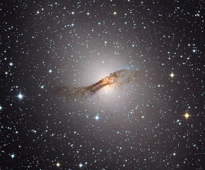 The galaxy Centaurus A, where scientists studying the galaxy and several dwarf galaxies surrounding it are stumped by their behavior. (Capella Observatory / Tribune News Service)