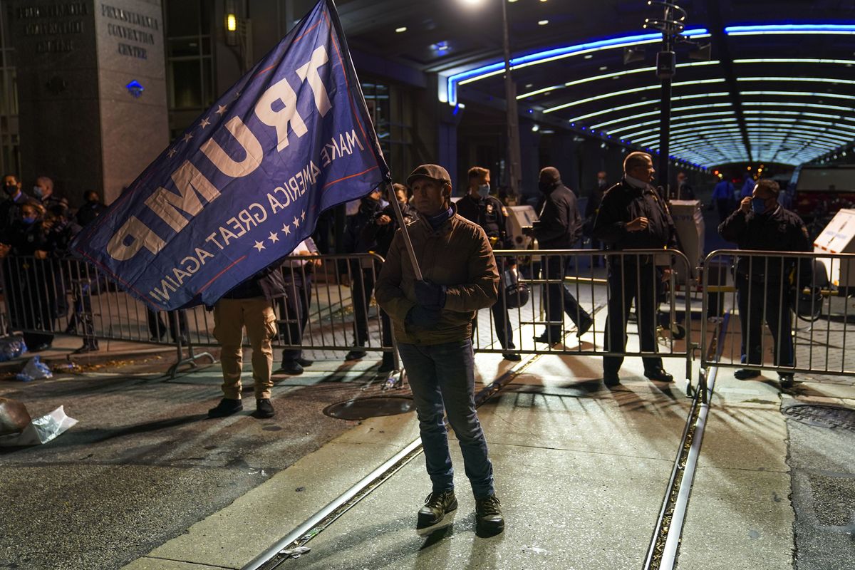 A Trump supporter stands outside the Pennsylvania Convention Center where votes are being counted, Thursday, Nov. 5, 2020, in Philadelphia. (John Minchillo/Associated Press)