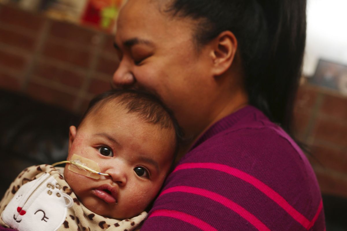 Days before Christmas, Elise Pele holds daughter Tatiana Saiaana at their Seattle home. Doctors used a once-abandoned drug to treat the baby’s extreme respiratory distress. (Ken Lambert)