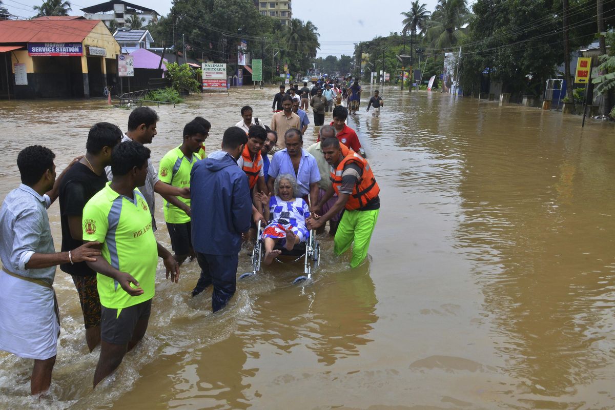 An elderly woman is evacuated to a safer area Thursday, Aug. 16, 2018, in Thrissur, in the southern Indian state of Kerala. Rescuers used helicopters and boats on Friday to evacuate thousands of people stranded on their rooftops following unprecedented flooding in the southern Indian state of Kerala that left more than 100 dead. (Associated Press)