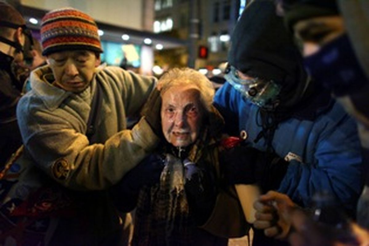 Seattle activist Dorli Rainey, 84, reacts after being hit with pepper spray during an Occupy Seattle protest on Tuesday, Nov. 15, 2011 at Westlake Park in Seattle. Protesters gathered in the intersection of 5th Avenue and Pine Street after marching from their camp at Seattle Central Community College in support of Occupy Wall Street. Many refused to move from the intersection after being ordered by police. Police then began spraying pepper spray into the gathered crowd hitting dozens of people. (Joshua Trujillo / Associated Press/seattlepi.com)