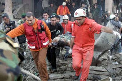 
Rescue personnel evacuate a man who was seriously wounded in the bombing.
 (Associated Press photos / The Spokesman-Review)