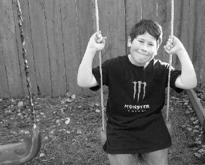 
Bradley Haubert, aspiring stand-up comic and wrestler, sits on the swing in the backyard of his North Spokane neighborhood. 