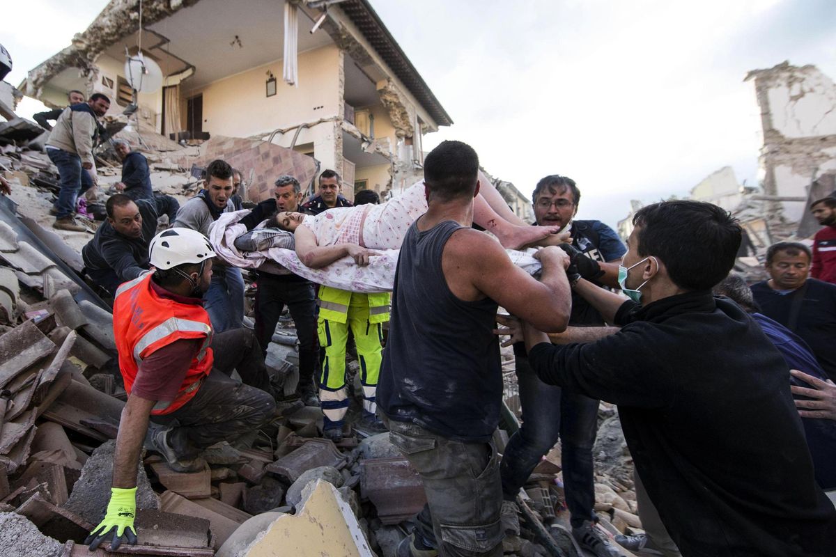 A rescued woman is carried away on a stretcher following an earthquake in Amatrice Italy, Wednesday, Aug. 24, 2016. The magnitude 6 quake struck at 3:36 a.m. (0136 GMT) and was felt across a broad swath of central Italy, including Rome where residents of the capital felt a long swaying followed by aftershocks. (Massimo Percossi / Associated Press)