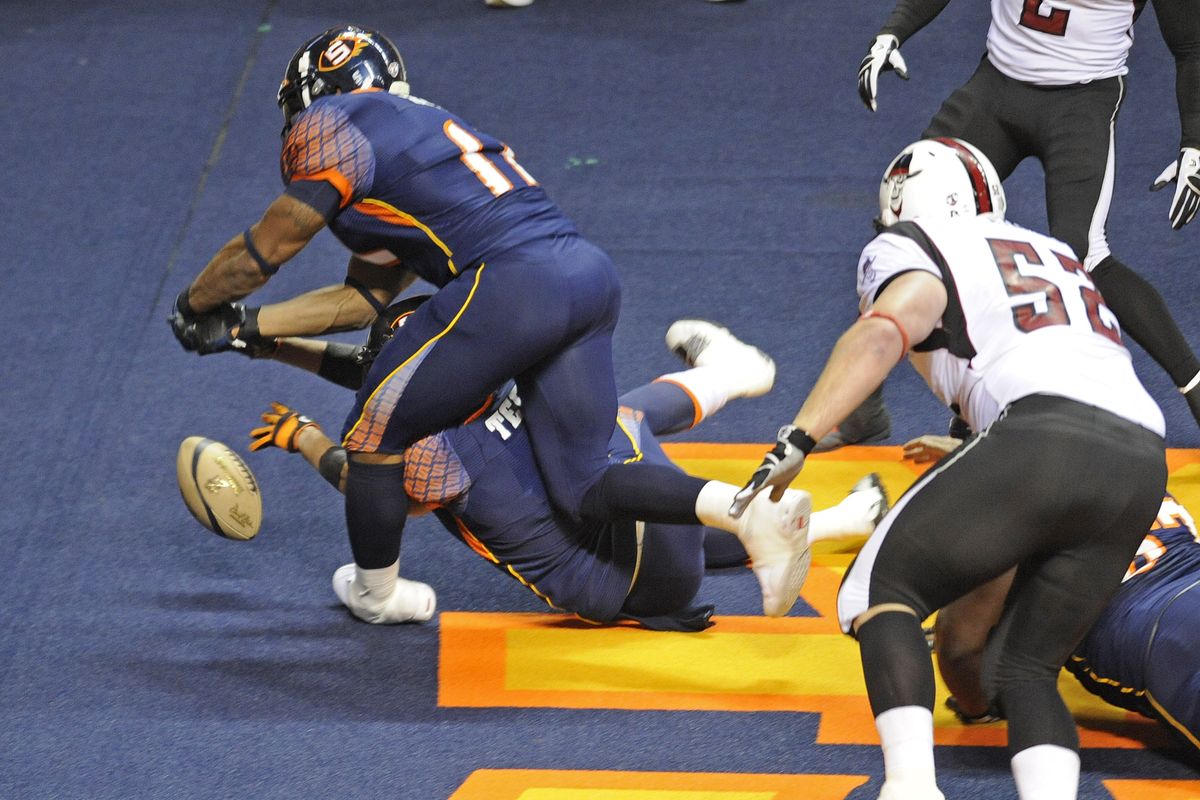 On the first play from scrimmage Spokane Shock players Micah King, top, and Alex Teems try to recover a Dallas fumble in the endzone. They were unable to corral the ball and Dallas went on to score on the drive, Saturday, May 14, 2011, in the Spokane Arena. (Christopher Anderson / The Spokesman-Review)