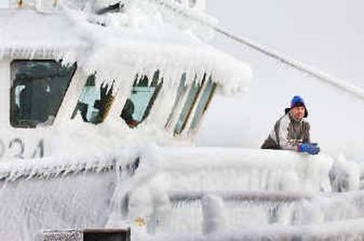 
Jose Joncalves, an engineer on the Nordic Explorer, watches from the ice-covered bow in Portland, Maine, where the mercury dropped to minus 11 degrees. 
 (Associated Press / The Spokesman-Review)