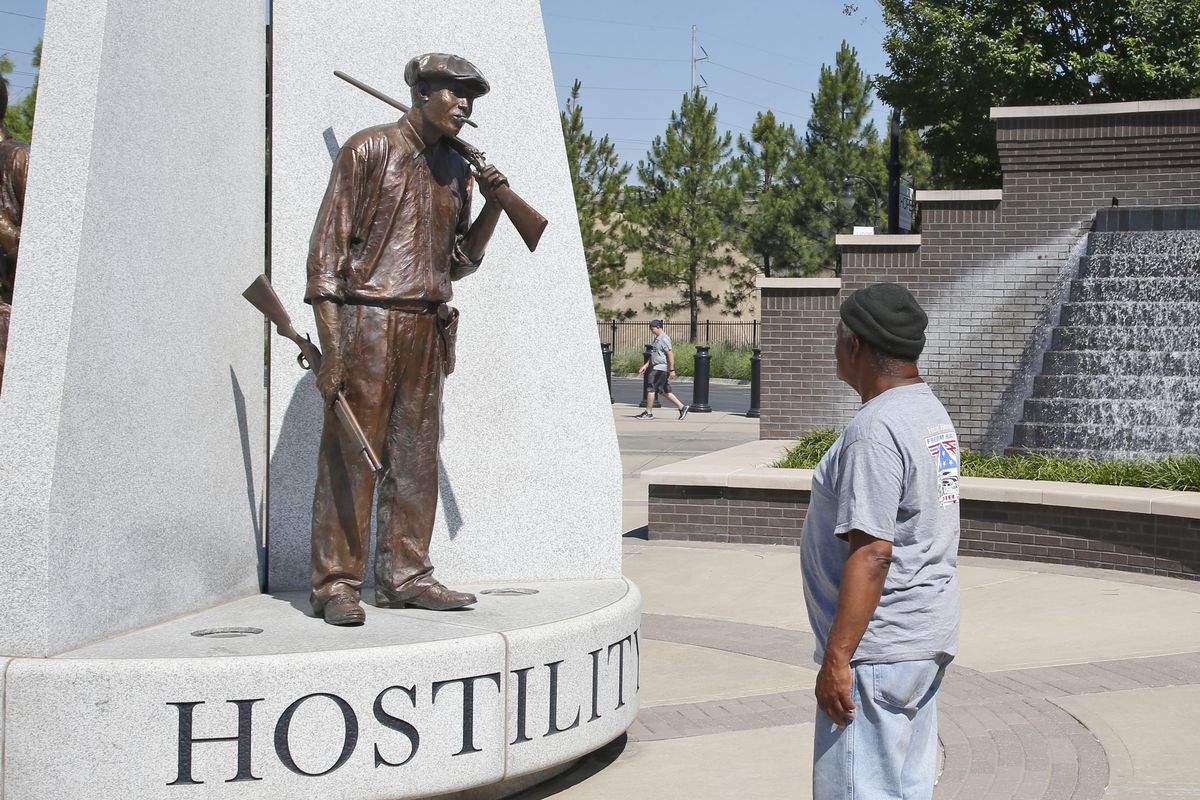 Donald Shaw looks at a sculpture in the John Hope Franklin reconciliation park in Tulsa, Okla., Monday, June 15, 2020, a few hundred yards and on the other side of what